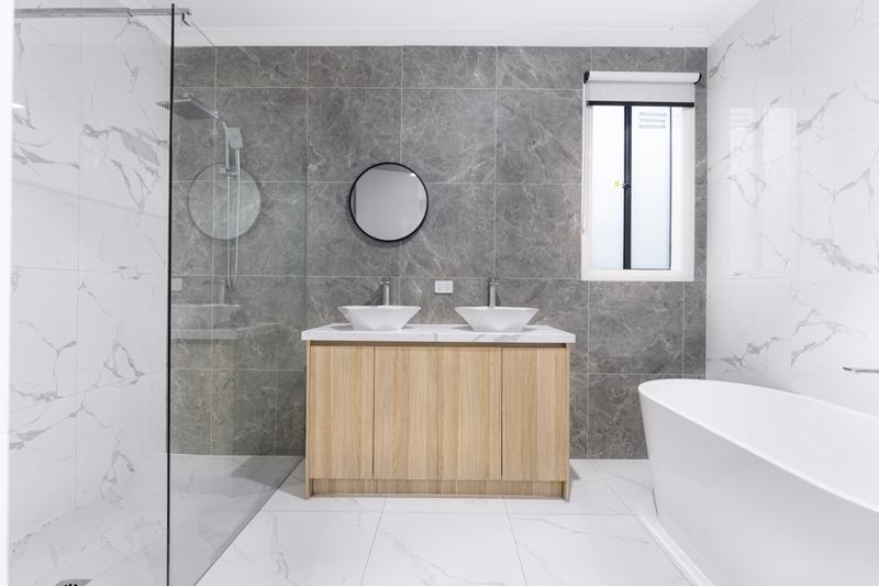 bathroom mirror, faucet, and vanity cabinet